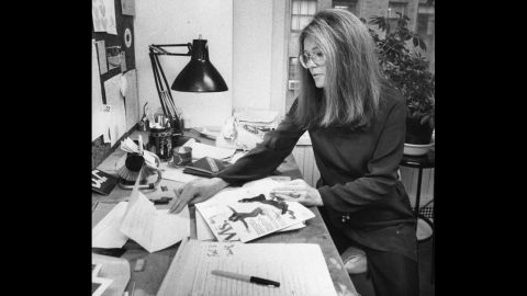 Steinem looks over a copy of Ms. magazine at her desk in 1980.