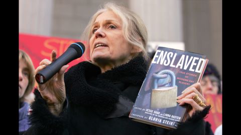Steinem holds up a copy of her book "Enslaved" as she speaks during a 2007 protest on the steps of the state Supreme Court in Albany, New York.