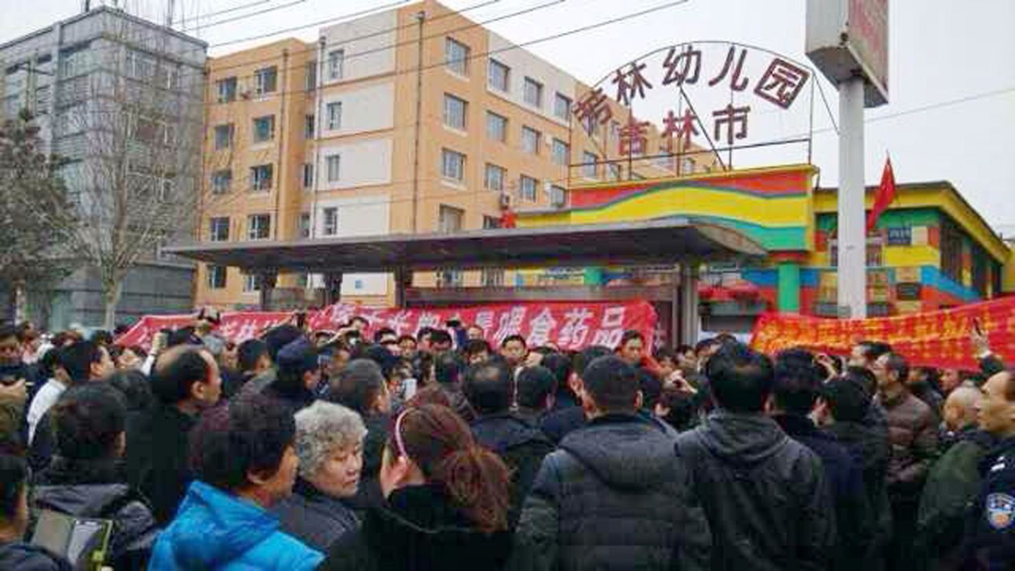 Chinese parents gather in front of the Fanglin Kindergarten in Jilin city, over the school's feeding of a prescription drug to their children on March 17. 
