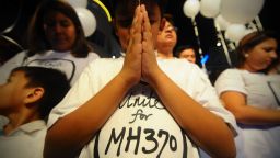 A young Malaysian boy prays, at an event for the missing Malaysia Airline, MH370, at a shopping mall, in Petaling Jaya, on the outskirts of Kuala Lumpur, Malaysia, Tuesday, March 18, 2014. A coalition of 26 countries, including Thailand, are looking for Malaysia Airlines Flight 370, which vanished March 8 with 239 people aboard on a night flight from Kuala Lumpur to Beijing. Search crews are scouring two giant arcs of territory amounting to the size of Australia — half of it in the remote seas of the southern Indian Ocean. (AP Photo/Joshua Paul)