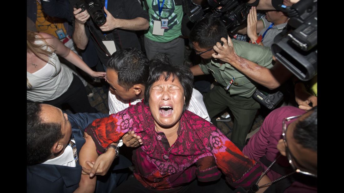 A distraught relative of a missing passenger breaks down while talking to reporters at Kuala Lumpur International Airport on March 19, 2014.