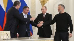 Left to right: Crimean Prime Minister Sergei Aksyonov, Crimean parliament speaker Vladimir Konstantionov, Russia's President Vladimir Putin, and Sevastopol's new de facto mayor Alexei Chaly join hands in Moscow after signing a treaty which annexed Crimea with Russia on March 18.