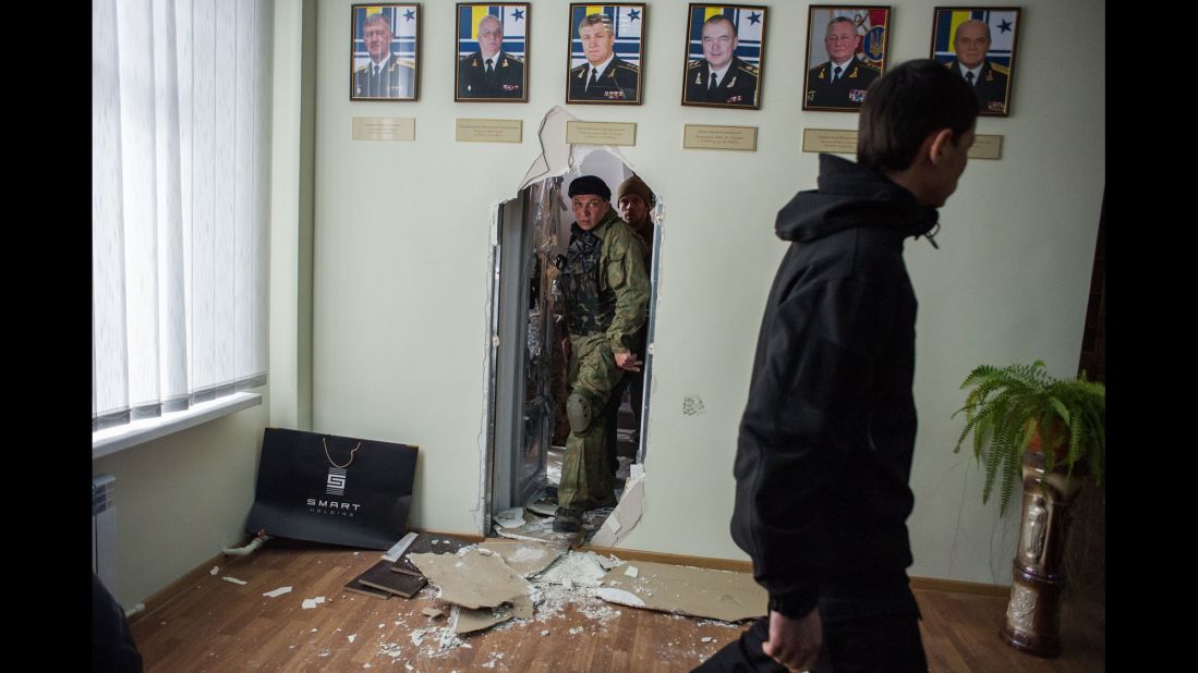 Pro-Russian forces walk inside the Ukrainian navy headquarters in Sevastopol on March 19.