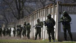Russian military personnel surround a Ukrainian military base in Perevalnoe, Ukraine, on March 19.