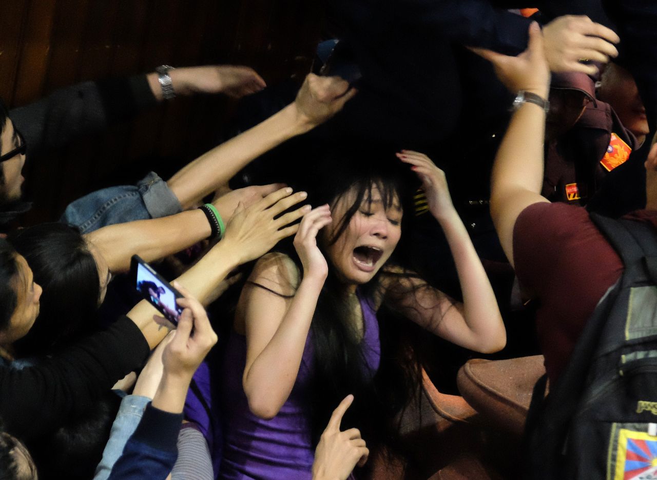 A protester shouts as police officers try to remove the chairs that block the entrance of the Legislature on March 19.