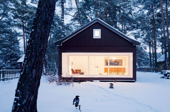 <em>Forest House, Germany</em><br /><br />The dark wooded facade and gently overhanging roof of this cottage south of Berlin evoke the mystery of fairy tales and dwellings in the deep forest. The large bay window that follows the length of the facade allows inhabitants to be immersed in the nature which surrounds them, even in cold weather. The architects, <a  target="_blank" target="_blank">Atelier St Gesellschaft von Architekten mbH</a>, made sure they referenced the simplicity of the older house that previously stood on the site. 