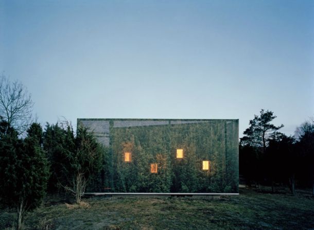 <em>Juniper House, Sweden</em><br /><br />This beautifully camouflaged house was a project of personal significance for architect<a  target="_blank" target="_blank"> Hans Murman</a>, who designed it as a weekend getaway for his family. Set within a grove of tall junipers, the exterior is wrapped in a cloth photographic reproduction of the surrounding trees, giving it a sense of calm and oneness with the nature. Through the low-placed windows, inhabitants can sneak a peak at wild rabbits scurrying along the grass in the morning. 