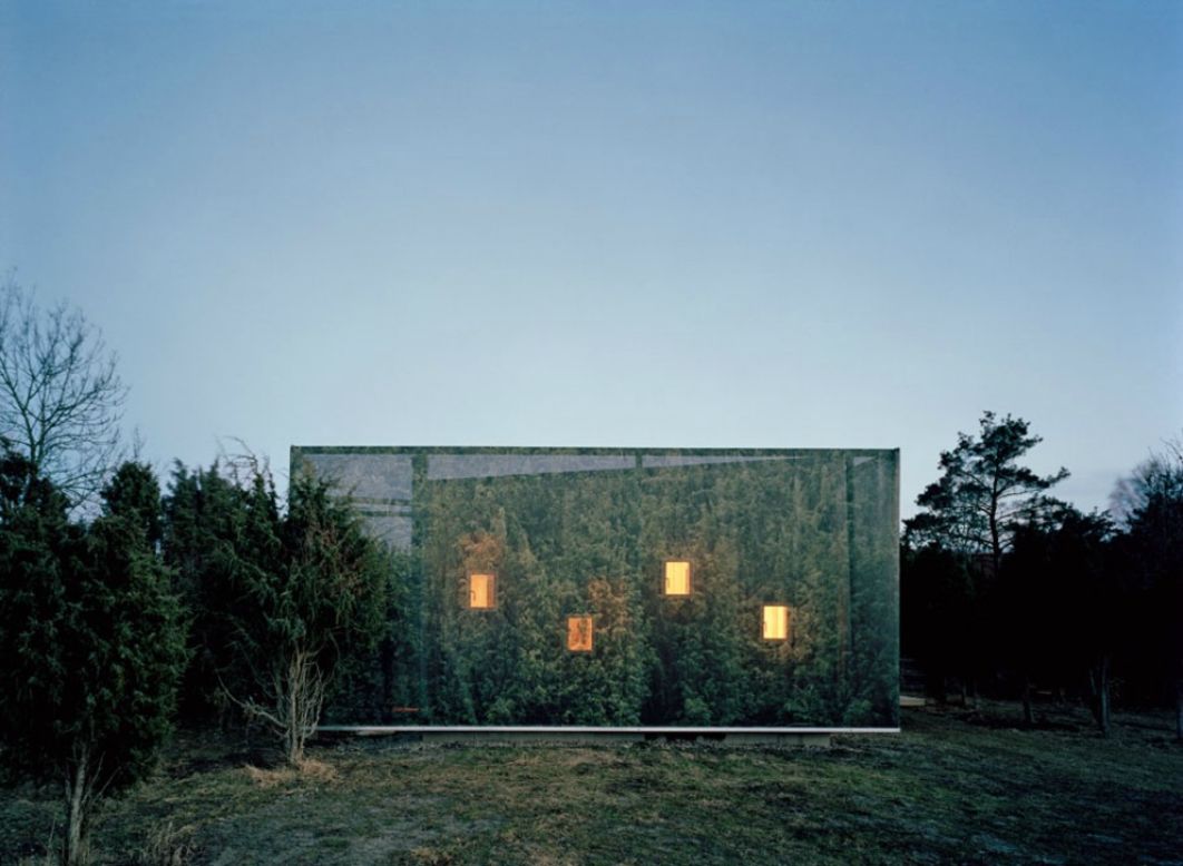 <em>Juniper House, Sweden</em><br /><br />This beautifully camouflaged house was a project of personal significance for architect<a href="http://www.murman.se/#!/juniper/juniper.htm" target="_blank" target="_blank"> Hans Murman</a>, who designed it as a weekend getaway for his family. Set within a grove of tall junipers, the exterior is wrapped in a cloth photographic reproduction of the surrounding trees, giving it a sense of calm and oneness with the nature. Through the low-placed windows, inhabitants can sneak a peak at wild rabbits scurrying along the grass in the morning. 