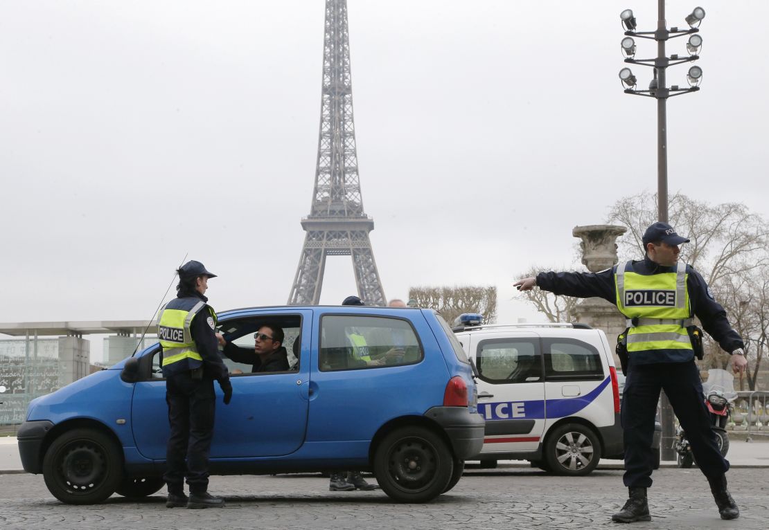 Police check cars are conforming to the temporary ban as Paris attempts to improve its air quality.