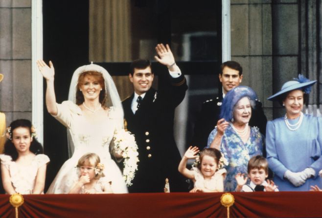 The newly wed Prince Andrew, the Duke of York and his wife Sarah Ferguson, the Duchess of York, wave to crowds July 23, 1986 from the balcony of Buckingham Palace in London while Queen Elizabeth II and Queen Mother look on.