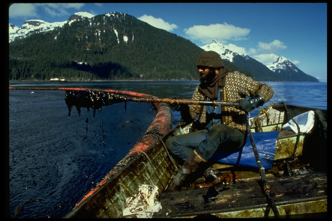 A cleanup worker checks gunk trapped in Prince William Sound after the Exxon Valdez oil spill. 