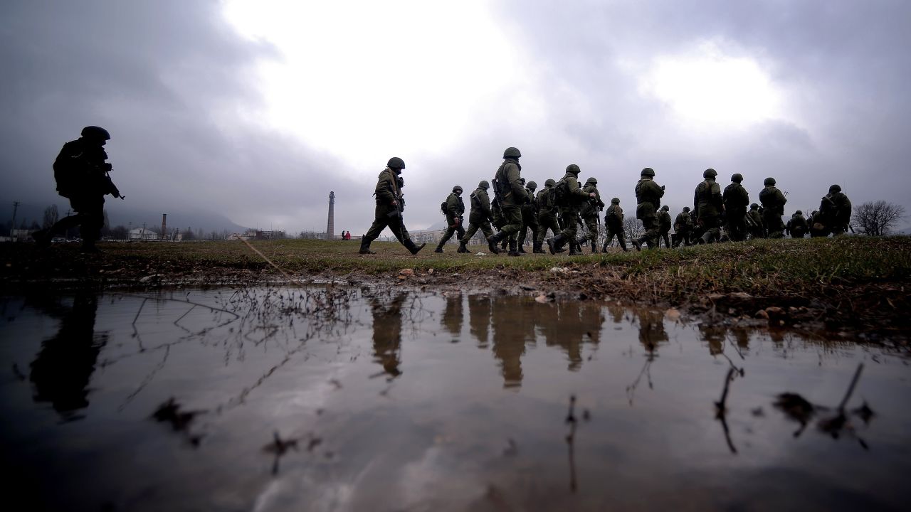 Russian soldiers patrol the area surrounding a Ukrainian military unit in Perevalne on Thursday, March 20.
