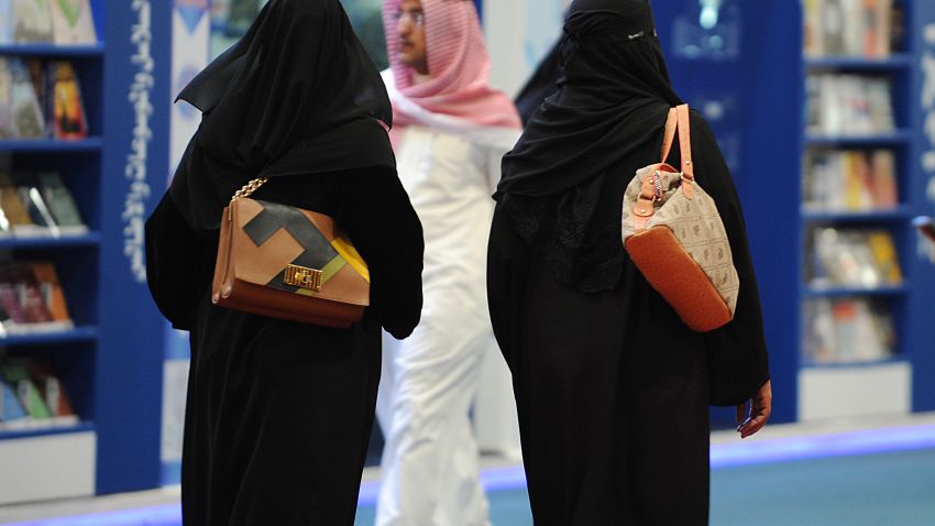Fully veiled Saudi women browse the annual International Book Exhibition in the capital Riyadh on March 4, 2014.