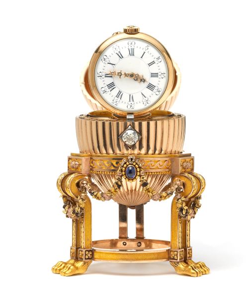 The diamond mechanism opens the egg to reveal a Vacheron Constantin watch inside. The gold watch with diamond hands is hinged to stand upright.