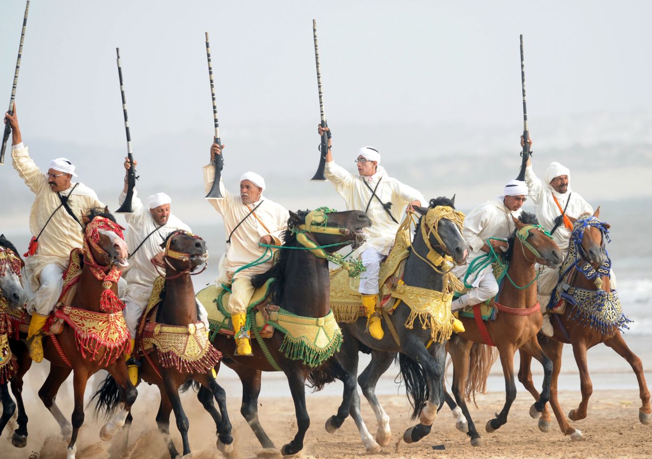Moroccan horsemen ride along Essaouira's beach<br />at the 2012 Gnaoua World Music Festival.