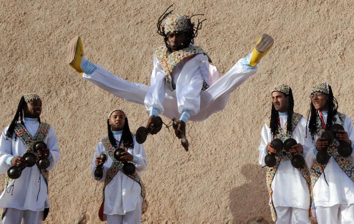 There's more to Essaouira than surfing. The historic town is known for its Gnawa, or Gnaoua,  music, which originated in West Africa. Pictured, members of a Gnaoua troupe parade along a street in Essaouira ahead of the Gnaoua World Music Festival. 