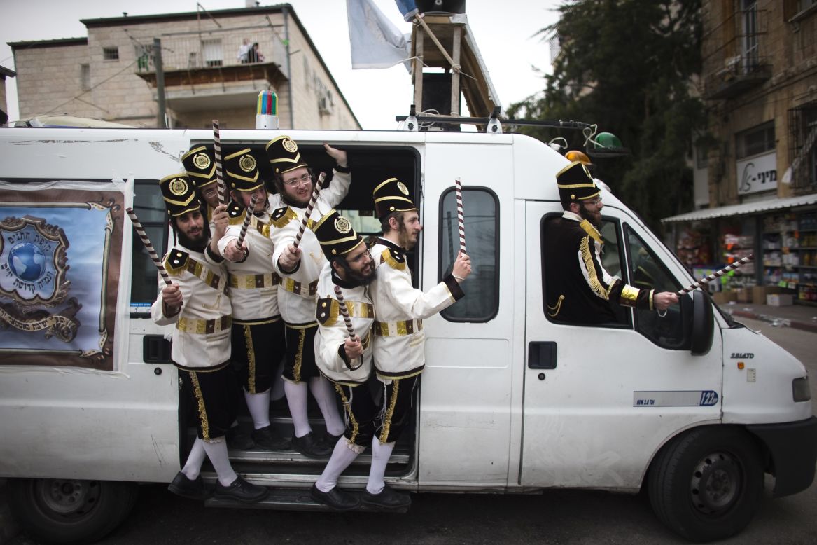 Ultra-Orthodox Jewish men wear costumes as they celebrate the Purim holiday Monday, March 17, in Jerusalem.