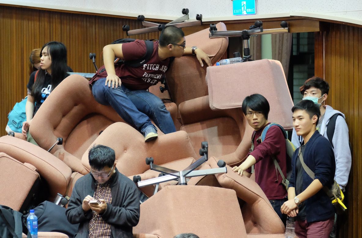 Protesters use chairs to block the entrance of Taiwan's Legislature on Wednesday, March 19, after occupying the building in Taipei, Taiwan. The protesters, mostly university students, are <a href="http://www.cnn.com/2014/03/19/asia/gallery/taiwan-protests/index.html">against the ruling party's push</a> for a trade pact with China.