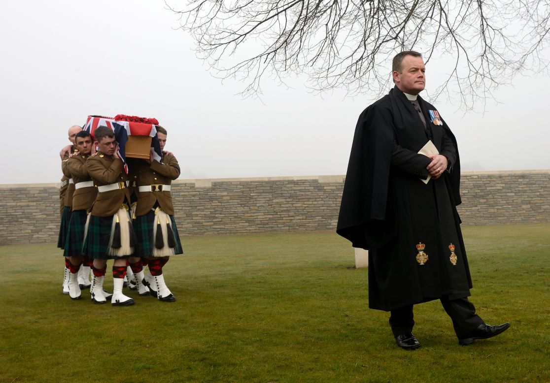 Soldiers carry the flag-draped casket of British soldier William McAleer during McAleer's funeral Friday, March 14, in Loos-en-Gohelle, France. Nearly 100 years after they were killed in the Battle of Loos during World War I, 20 British soldiers were buried at Loos British Cemetery. Their remains were found in 2010.