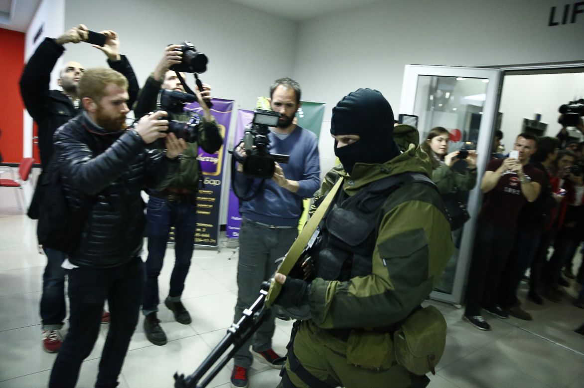 An armed man leaves the Moscow Hotel in Simferopol, Crimea, on Saturday, March 15. Russian President Vladimir Putin announced the annexation of Ukraine's Crimea region a couple of days after voters in the semi-autonomous territory approved a referendum on <a href="http://www.cnn.com/2014/02/24/world/gallery/ukraine-in-transition/index.html">separating from Ukraine</a>.