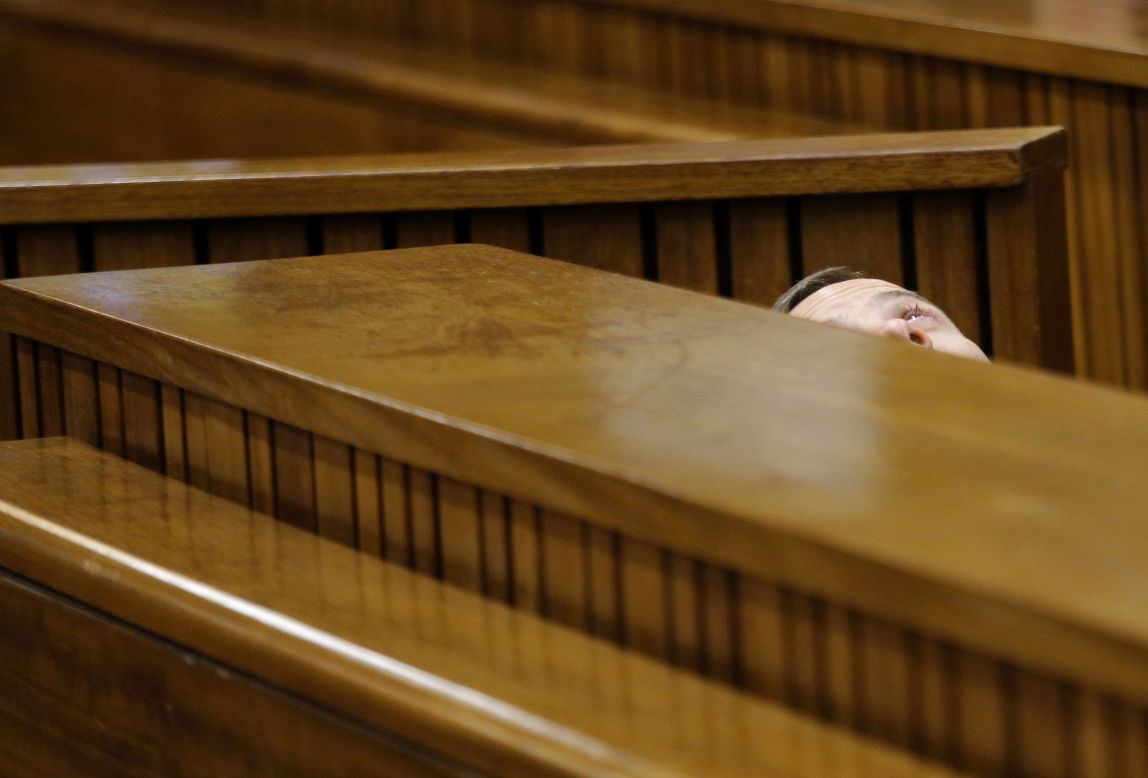 Oscar Pistorius leans back after applying eye drops in court Friday, March 14, during <a href="http://www.cnn.com/2014/03/03/africa/gallery/pistorius-2014-trial/index.html">his trial in Pretoria, South Africa</a>. Pistorius, the first double amputee runner to compete in the Olympics, is accused of intentionally killing his girlfriend, Reeva Steenkamp, in February 2013. Pistorius has pleaded not guilty to murder and three other weapons charges.