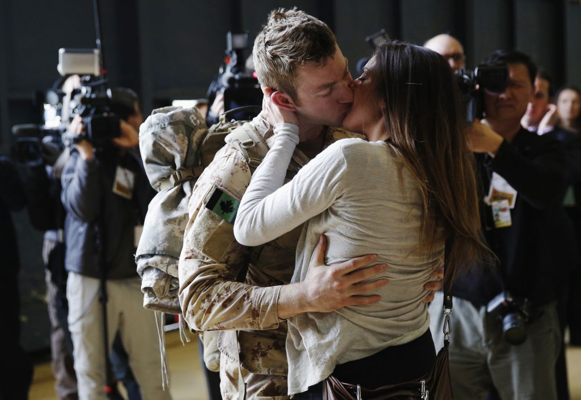 Master Cpl. Anthony Alliot of the Canadian Army kisses Sarah Tooth after arriving home from Afghanistan on Tuesday, March 18. Canada's 12-year mission in Afghanistan is now over, its military said.