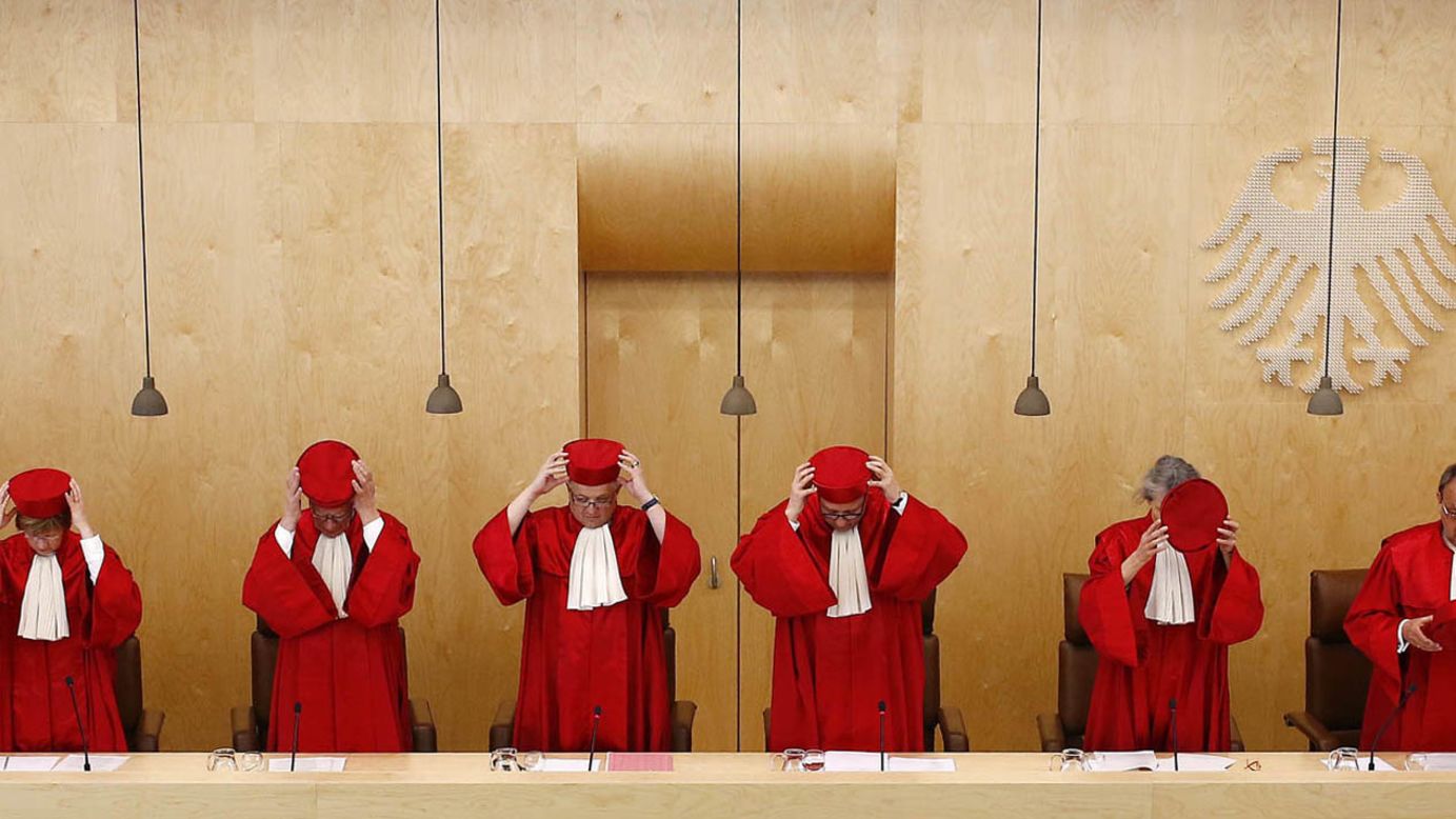 The Second Senate of Germany's Federal Constitutional Court takes off their hats prior to a verdict in Karlsruhe on Tuesday, March 18.