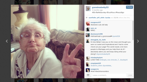 Grandma Betty flashes a peace sign while sporting "duck face."