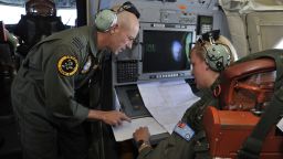 Royal Australian Air Force personnel discuss the search area aboard the Royal Australian Airforce AP-3C Orion, some 2,500 km southwest of Perth over the Indian Ocean on March 21.