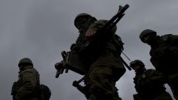 Pro-Russian soldiers march outside an Ukrainian military base in Perevalne, Crimea, Thursday, March 20, 2014.