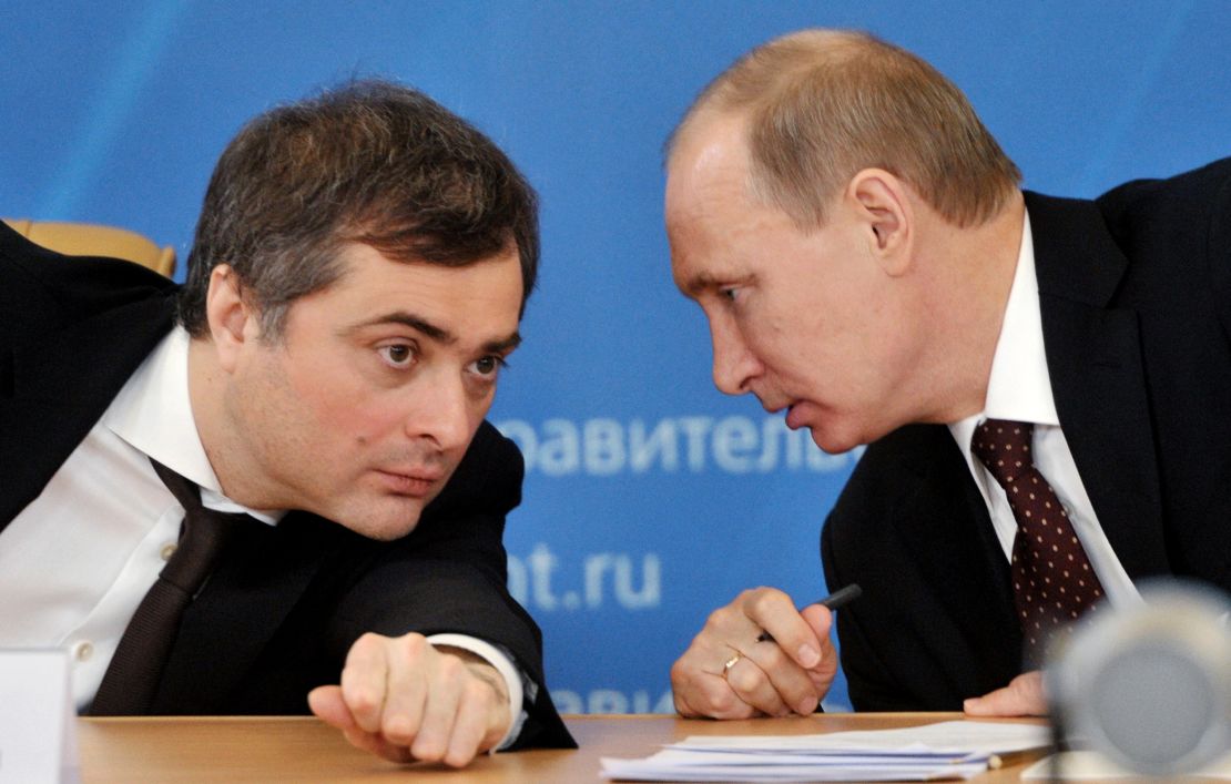 The then Prime Minister Vladimir Putin (right) confers with his deputy Vladislav Surkov during a meeting in 2012.