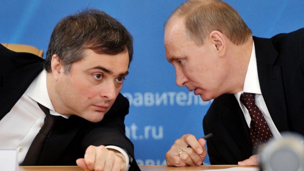 The then Prime Minister Vladimir Putin (right) confers with his deputy Vladislav Surkov during a meeting in 2012.