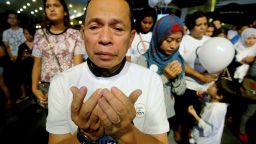 In this picture taken on Tuesday, March 18, 2014 a Malaysian Muslim man prays during an interfaith event for the missing Malaysia Airlines flight MH370 at a shopping mall in Petaling Jaya outside Kuala Lumpur, Malaysia.