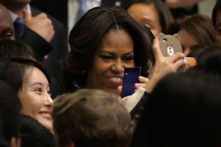 A Chinese student takes pictures with her phone besides first lady Michelle Obama, center, after Mrs. Obama spoke at the Stanford Center at Peking University on March 22 in Beijing, China. 