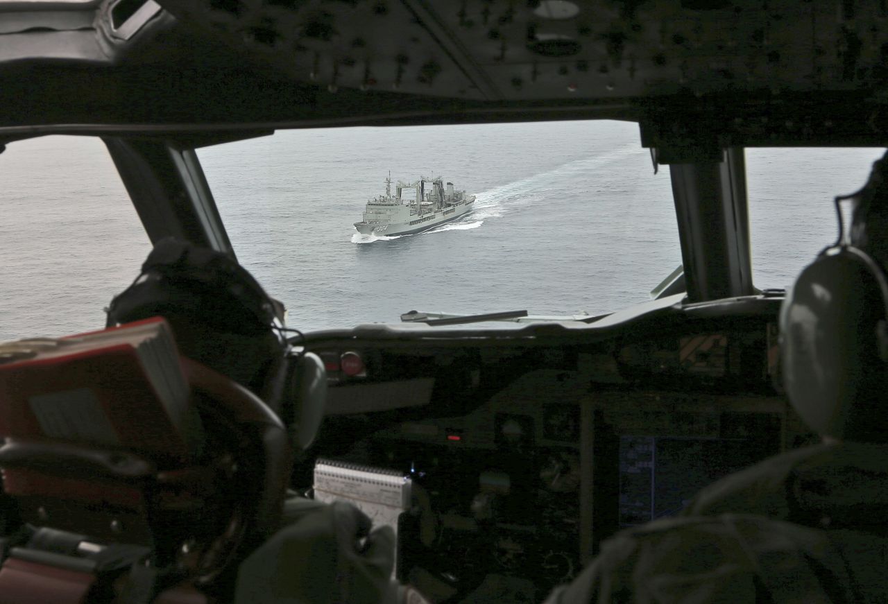 Flight Lt. Jason Nichols, on board a Royal Australian Air Force AP-3C Orion, looks towards HMAS Success as they search for signs of the missing plane on March 22.
