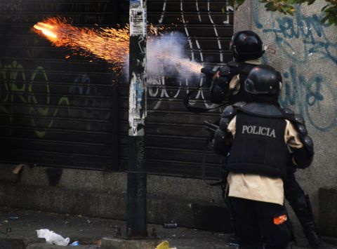 Riot police shoot tear gas during the March 22 protest. 