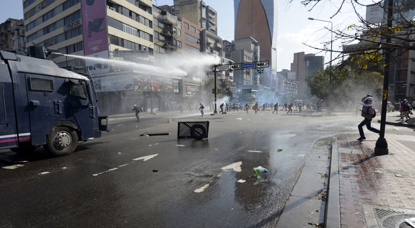 Law enforcement personnel use water cannons to disperse demonstrators on March 22.  