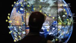 A passenger views a weather map in the departures terminal of Kuala Lumpur International Airport in Kuala Lumpur, Malaysia, on march 22. The search for missing Malaysia Airlines flight MH370 is entering its third week with no clear indication of the fate of the aircraft. Search efforts are focused on the Indian Ocean with reports of satellites capturing images of large floating debris.