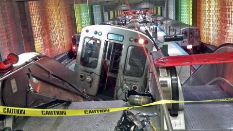 A commuter train car lies halfway up an escalator at Chicago's O'Hare International Airport station after derailing early Monday, March 24. More than 30 people were hurt, according to Chicago police, but the injuries weren't considered to be life-threatening.