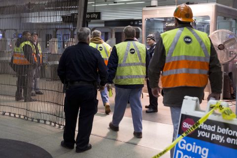 Chicago Transit Authority employees work the scene of the derailment.