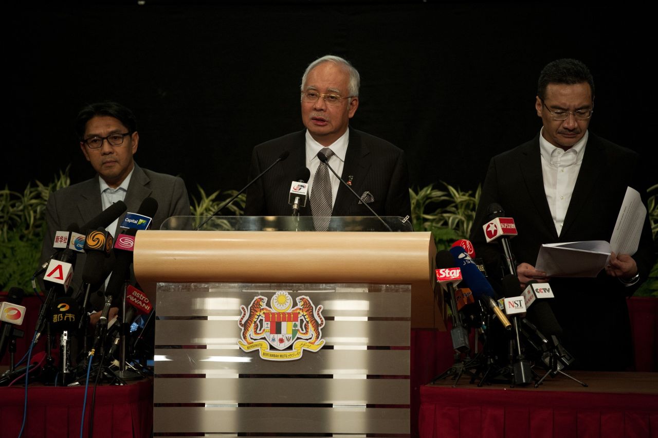 Malaysian Prime Minister Najib Razak, center, delivers a statement about the flight on March 24, 2014. Razak's announcement came after the airline sent a text message to relatives saying it "deeply regrets that we have to assume beyond any reasonable doubt that MH 370 has been lost and that none of those onboard survived."