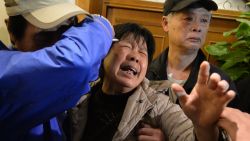 Relatives of passengers on Malaysia Airlines flight MH370 cry after hearing the news that the plane plunged into Indian Ocean at a hotel in Beijing on March 24, 2014.