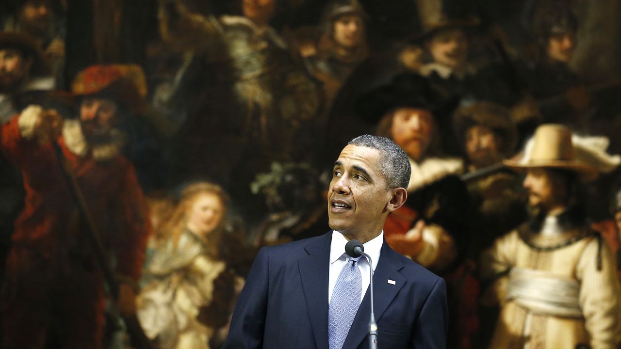 U.S. President Barack Obama stands in front of Dutch master Rembrandt's The Night Watch painting during a visit to Europe.