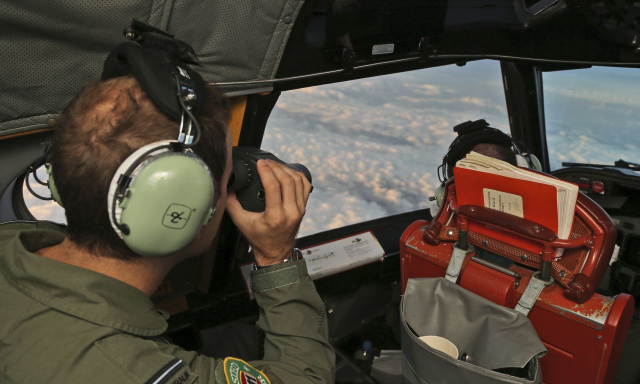 Crew aboard an Australian P-3 Orion "sub hunter" scan the southern Indian Ocean as they search for the missing plane on March 23. 