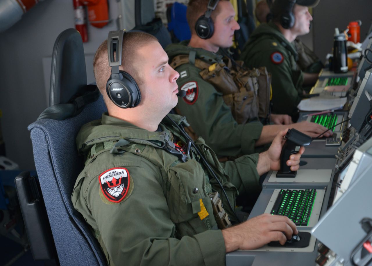 A U.S. airman monitors his instruments aboard a P-8 Poseidon during a mission in the southern Indian Ocean on March 23.