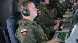 A U.S. airman monitors his instruments aboard a P-8 Poseidon during a mission to assist in search and rescue efforts on March 23.