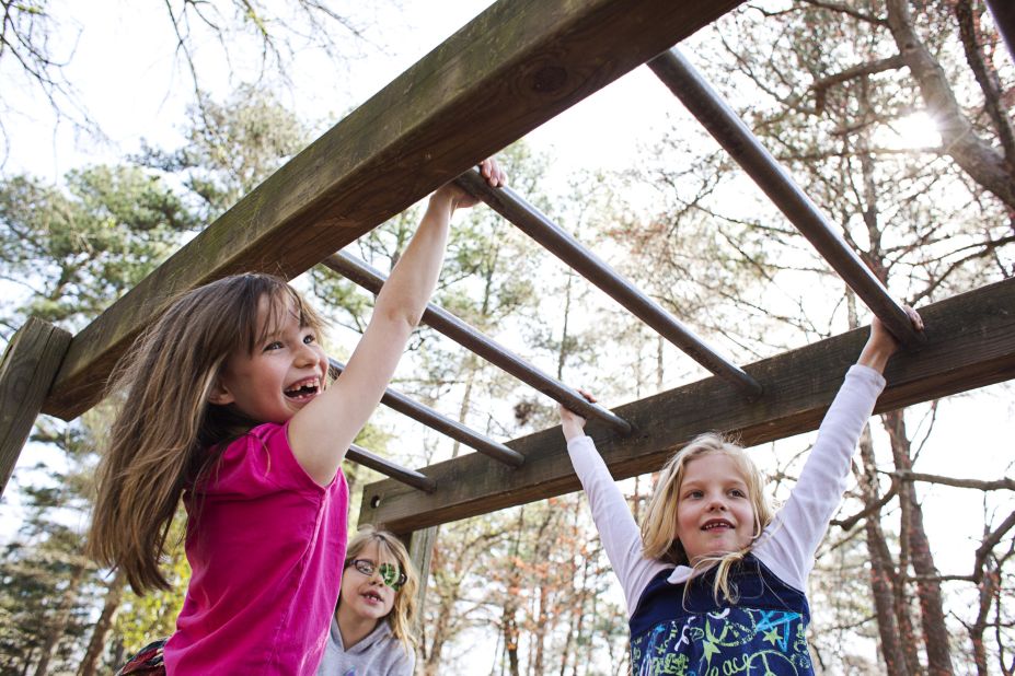 Students swing from the monkey bars at Hess Academy in Decatur, Georgia. Physical education and movement are key parts of the curriculum at the private school.