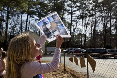 A student uses a template to identify different types of clouds. Students use the playground during free time, but also during classroom learning activities.
