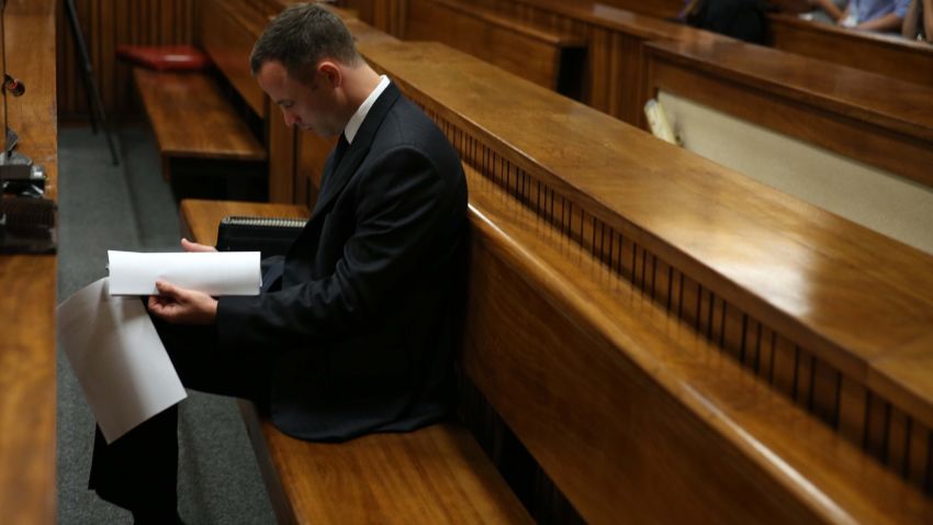 Paralympic track star Oscar Pistorius sits in the dock ahead of his trial for the murder of his girlfriend Reeva Steenkamp, at the North Gauteng High Court in Pretoria, on March 25, 2014. Oscar Pistorius's girlfriend Reeva Steenkamp told the athlete she was sometimes scared of him in a text message sent less than three weeks before he shot her dead, his murder trial heard Thursday. "I'm scared of you sometimes and how you snap at me and how you react to me," Steenkamp said via messaging service WhatsApp after the athlete apparently created a scene thinking that she had flirted with another man. AFP PHOTO / POOL - Esa Alexander        (Photo credit should read Esa Alexander/AFP/Getty Images)