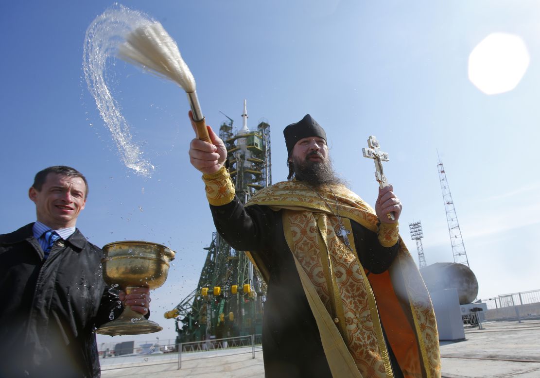 MARCH 26 - BAIKONUR, KAZAKHSTAN: An Orthodox priest conducts a blessing service in front of the Soyuz TMA-12M spacecraft at the Baikonur Cosmodrome. The start of the new Soyuz mission to the International Space Station (ISS) is scheduled for March 27.